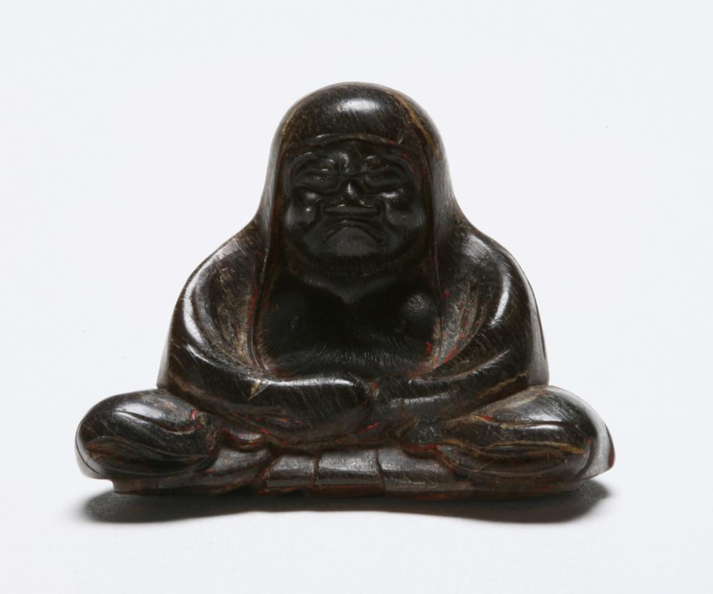 Horn netsuke of Daruma in meditation